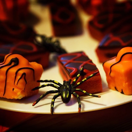 A spider lurks among some candy.